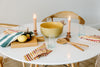 Tablescape with cutting boards, candles and cloth napkins