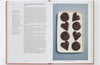 Open cookbook showing a recipe for Chocolate-Glazed Polish Gingerbread on the left page and a photo of chocolate-covered heart and circle-shaped cookies on a tray on the right page.