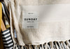 A beige towel labeled 