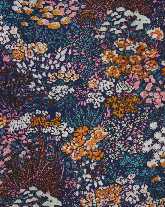 Vibrant floral fabric pattern with a mix of pink, orange, white, and blue flowers on a dark background for the Birds of Paradis Jacquelin Shirt in Bijou Glade by Trovata.