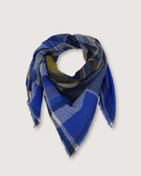 Moismont's Bandana No 752 in Royal Blue, featuring blue and gray checkered wool and fringed edges, is beautifully arranged in a triangular shape on a plain background, highlighting its handwoven craftsmanship.