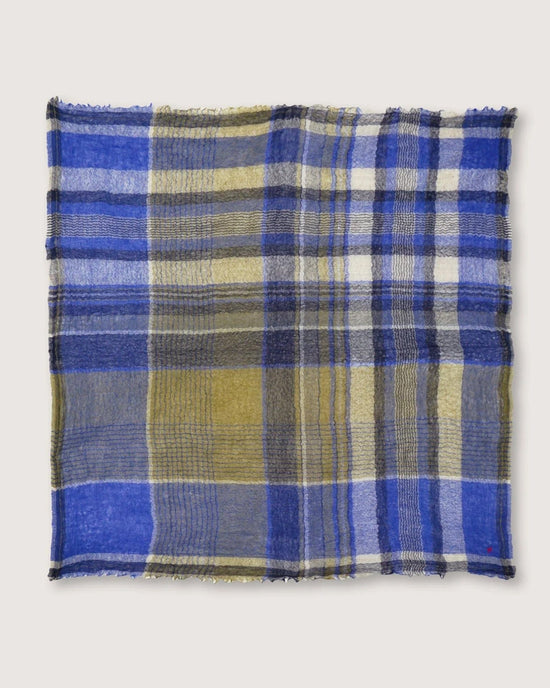 Moismont's Bandana No 752 in Royal Blue, with its oversized checkered wool design featuring stripes of blue, yellow, and gray, lies elegantly flat against a pristine white background.