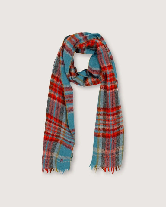 The Scarf No 699 in Cloud by Moismont is a hand-woven wool scarf with a plaid pattern featuring blue, red, and gray tones and finished with fringed ends.