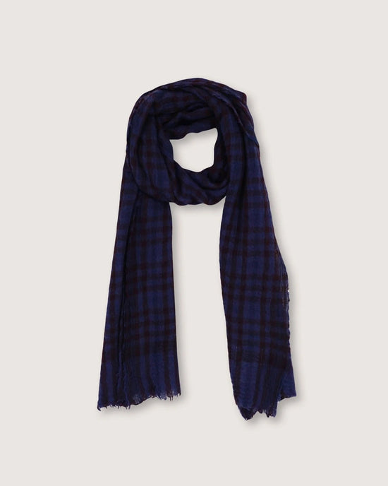 Presenting the sophisticated Scarf No 754 in Navy Blue, a hand-woven wool piece by Moismont. This exquisite accessory showcases a blue and black checkered pattern with fringed edges, ideal for adding a refined touch to any ensemble.