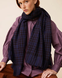 Person wearing a purple button-up shirt, rust-colored pants, and Scarf No 754 in navy blue by Moismont.