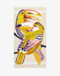 Two stylized toucans perched on a branch, featured on an Inoui Editions Fouta 100 Toucan in Nude.