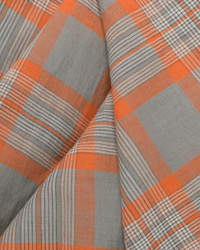 Close-up of the Varied Plaid Cotton Scarf in Cloud, a Moismont design featuring a hand-woven cotton fabric with orange, gray, and black plaid patterns. The folds highlight intersecting lines, creating a textured effect perfect for this chic plaid scarf.